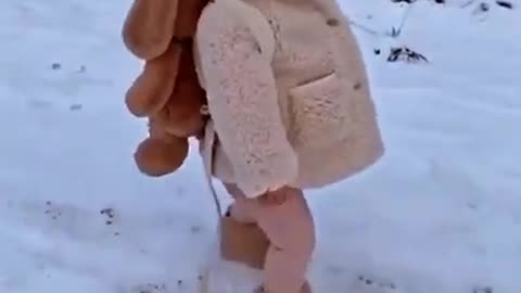 A Cute baby on snow fall