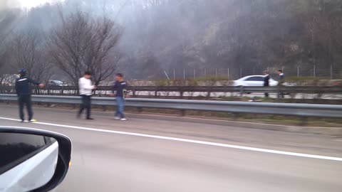 a burning car on the highway