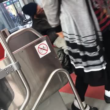 Man with long beard dances sitting down train