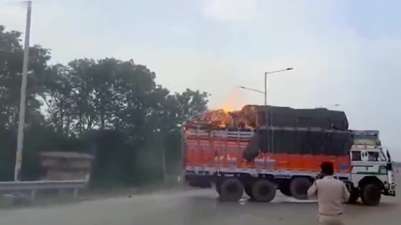 Oblivious driver drives burning truck amid road in central India