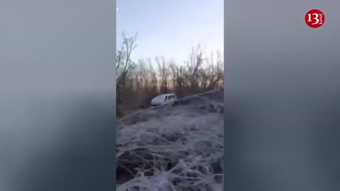 krainian soldiers display destroyed vehicles along the road in Bakhmut