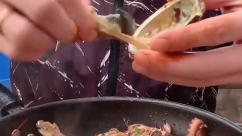 Jat Lee eating seafood