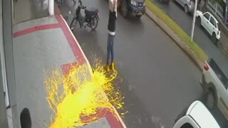 Dropping a paint bucket on the sidewalk