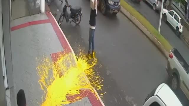 Dropping a paint bucket on the sidewalk