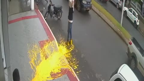 Dropping a paint bucket on the sidewalk