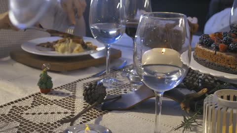 Elegant table with people eating at christmas dinner