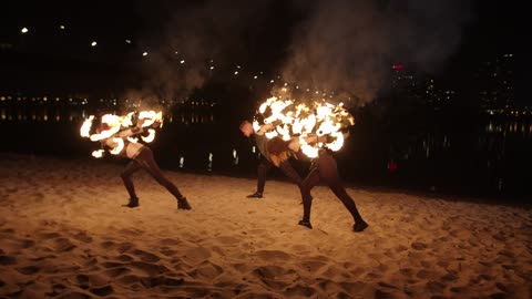 Fire jugglers on a beach