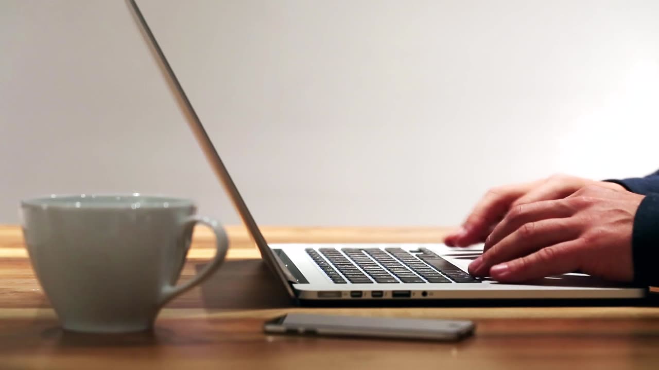 A man is typing on his brand-new notebook