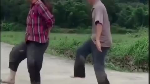 Couple with funny dance in the field