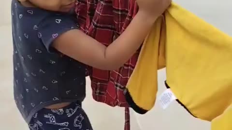 Baby shows the clothes that their family wore