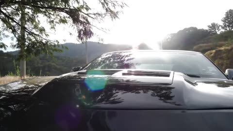 Sports car parked next to a highway