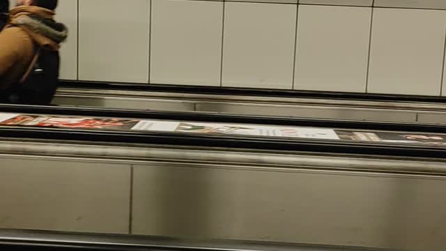 Tilted Escalator Riders in Budapest