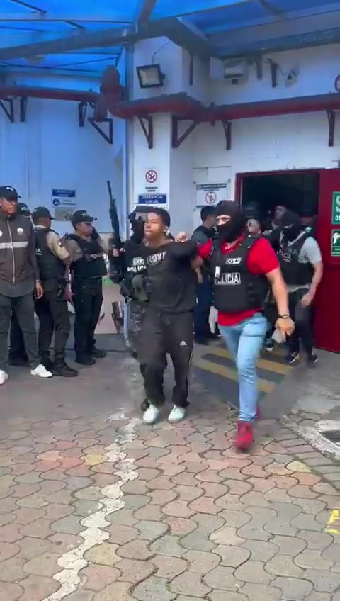 Footage of police escorting arrested cartel members out of the Ecuadorian Television studio.