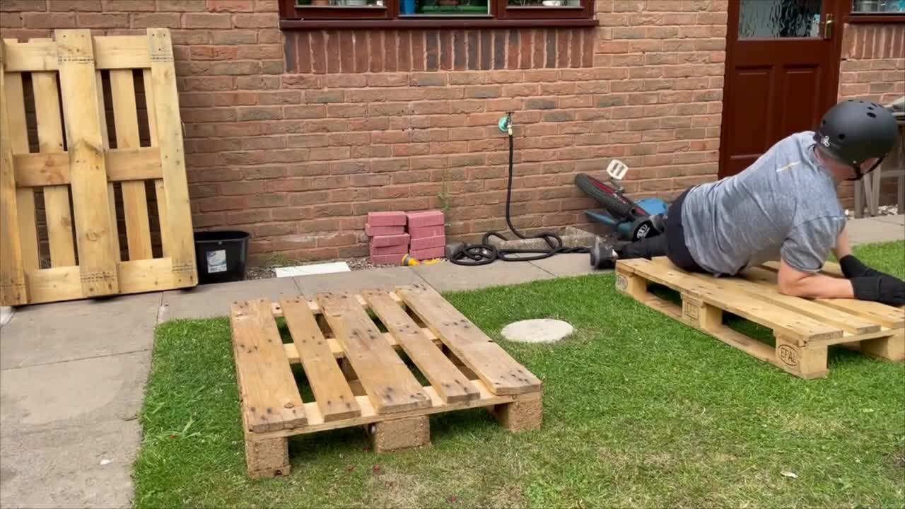 Trials Unicyclist Fails a Two Pallets Gap Then Falls