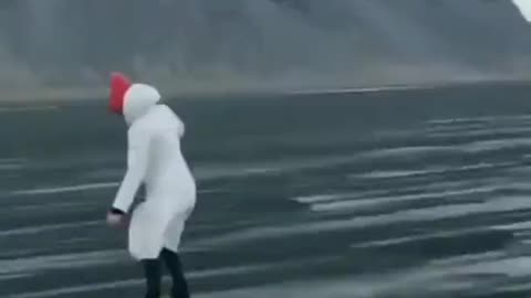 Wind blows through black sand on a beach in Iceland creates a rare phenomenon