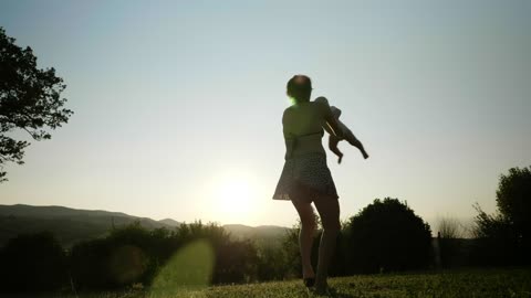 Mother spinning her baby