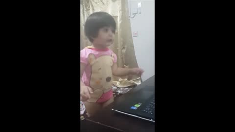 Toddler sings in front of mirror