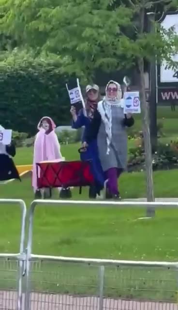 Muslim mothers walk their children through a Jewish neighborhood Swastikas