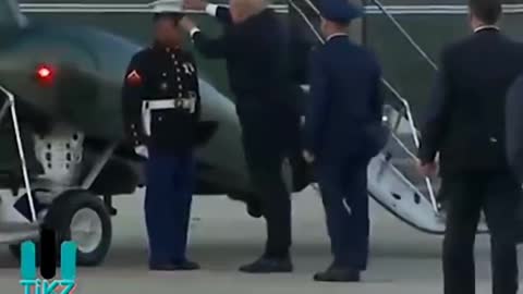 Trump Picks Up Ground Hat and Puts it on Soldier