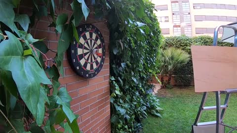 Guy Hits Bullseye Shooting A Dart Through A Moving Ring