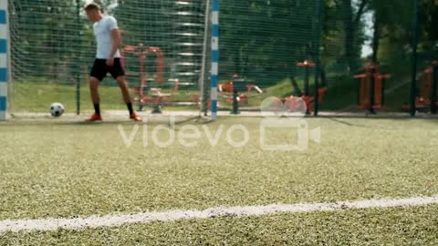 Close Up Of Soccer Player's Legs Executing Penalty Kick And Scoring A Goal