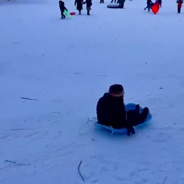 Kid enjoying sliding in snow