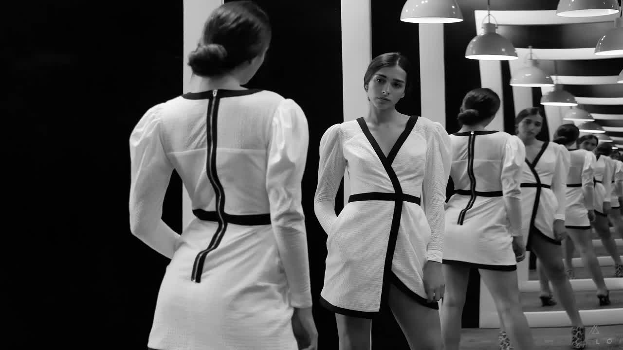 Fashion model in front of multiple mirrors