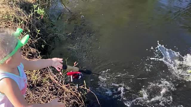 Daughter Reeling in First Fish Drops Pole