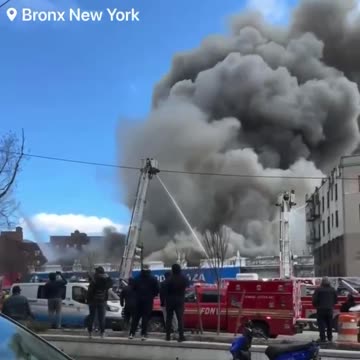 Multiple firefighters and other emergency personnel are battling a massive 5-alarm fire