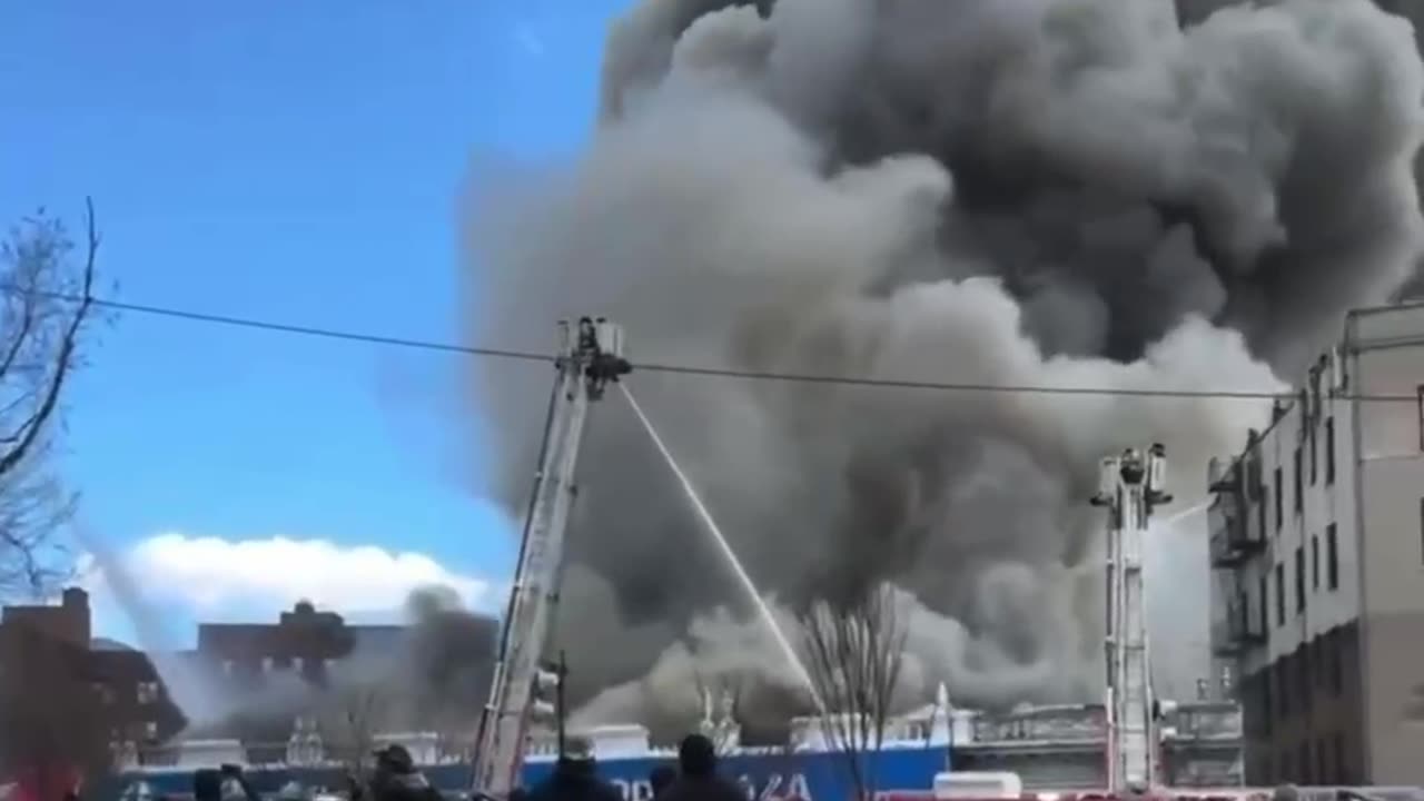 Multiple firefighters and other emergency personnel are battling a massive 5-alarm fire