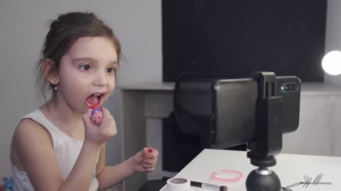 Baby girl applying makeup