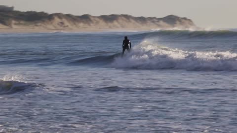 Surfers riding Atlantic Ocean waves at Cabedelo, Viana do Castelo, Portugal in January 2024 ~~~ 2