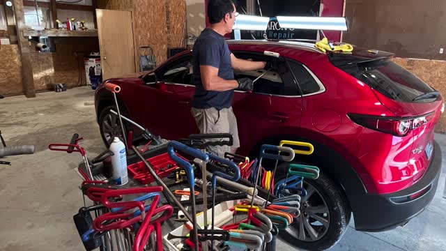 Paintless dent repair on a customer's vehicle