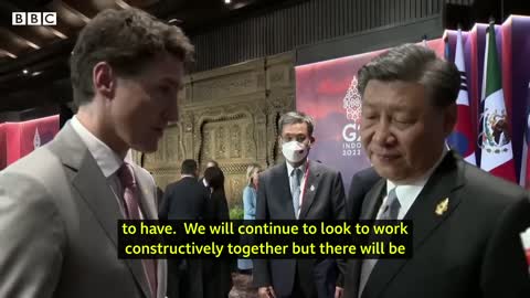 China and Canada leaders caught having tense exchange on camera - BBC News