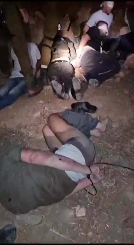 Israeli soldiers with detainees