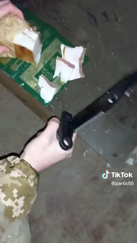 Ukraine's soldiers cut pork on the Quran Holy book.