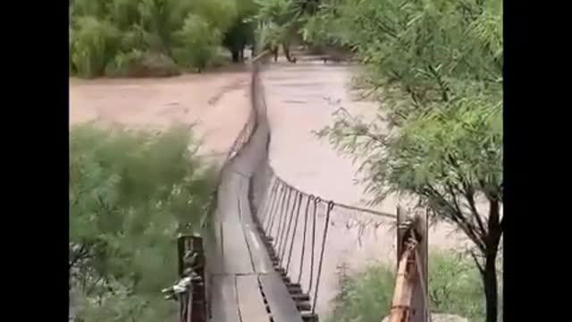 The swift current of the river makes the bridge sway