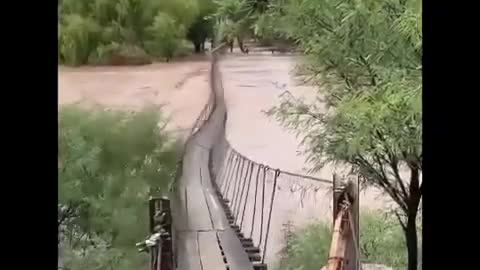 The swift current of the river makes the bridge sway