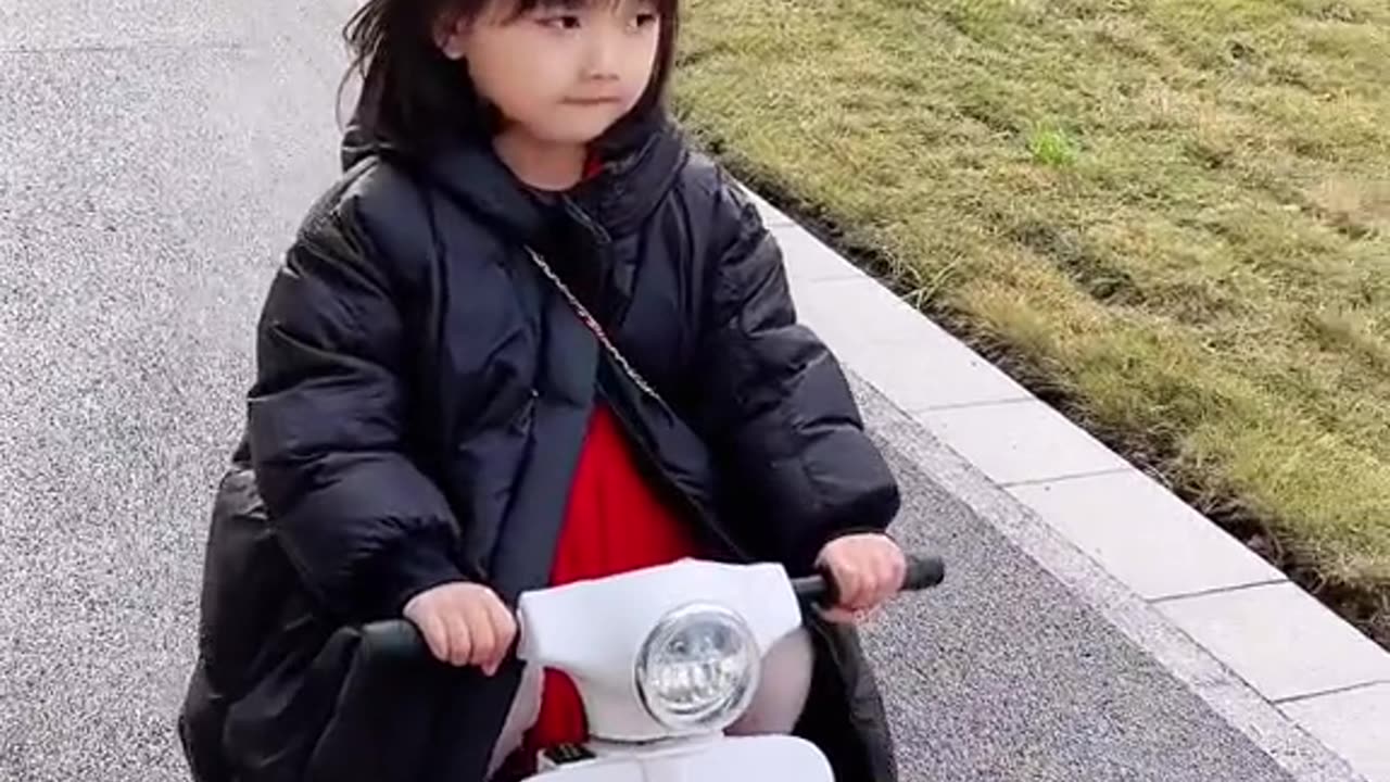 Super cute baby riding a motorbike