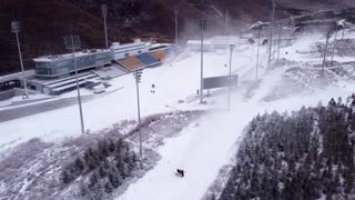 Making it stick: wind challenges snow makers at Games site