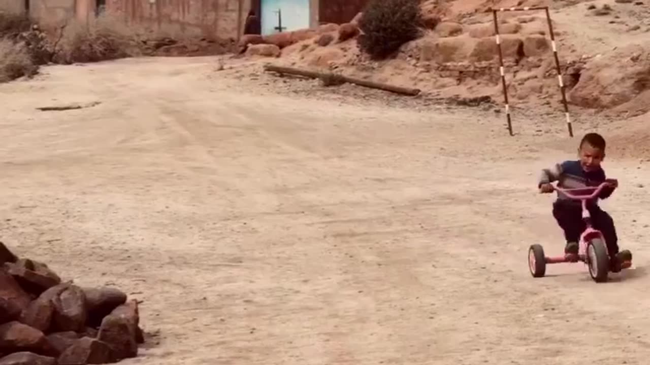 A Moroccan kid is excited to ride his bike with a great song