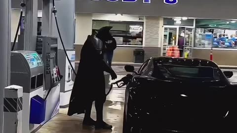 BATMAN FILLS UP AT THE LOCAL GAS STATION