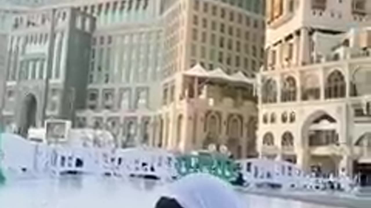 Litile girl play with Pigeon at macca saudi arab