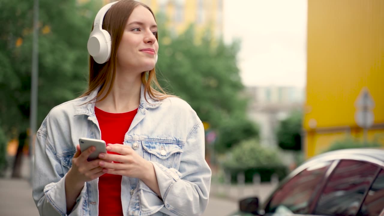 Pretty Young Woman Listening To Music With Wireless Headphones And Her...