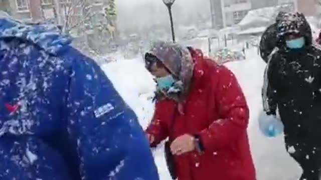 People Wait in the Snow for Mandatory Tests in China