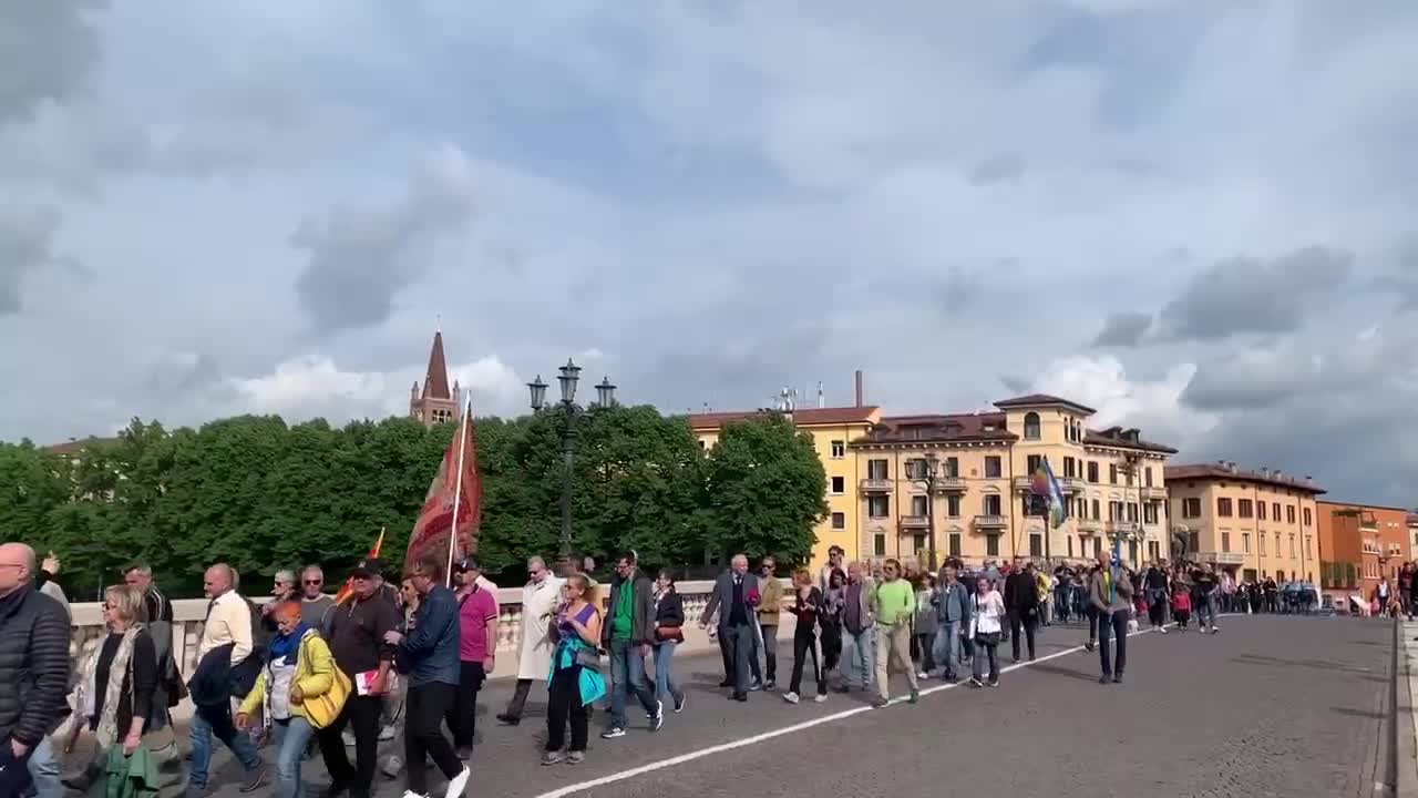 Crowd chanting "NATO is a killer" and carrying banners insulting Biden