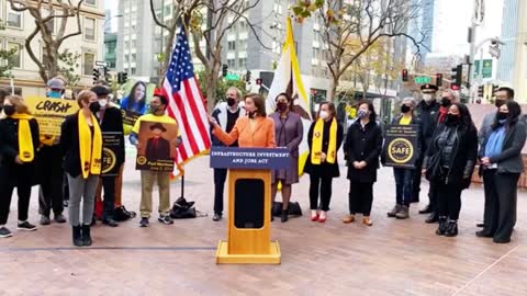 Nancy Pelosi gives a speech & a random patriot walks by screaming LET'S GO BRANDON