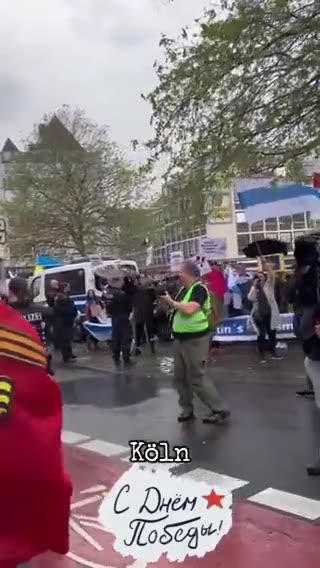 Cologne, Germany - WWII Victory day procession interrupted by people with Ukrainian flags