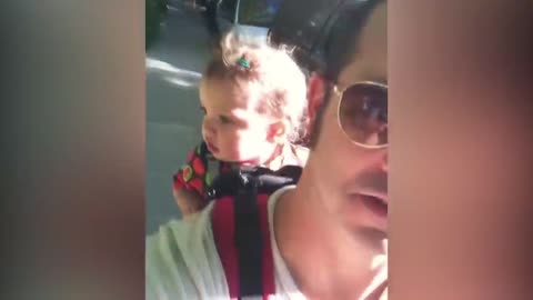 Baby has a serious conversation with his father, cute