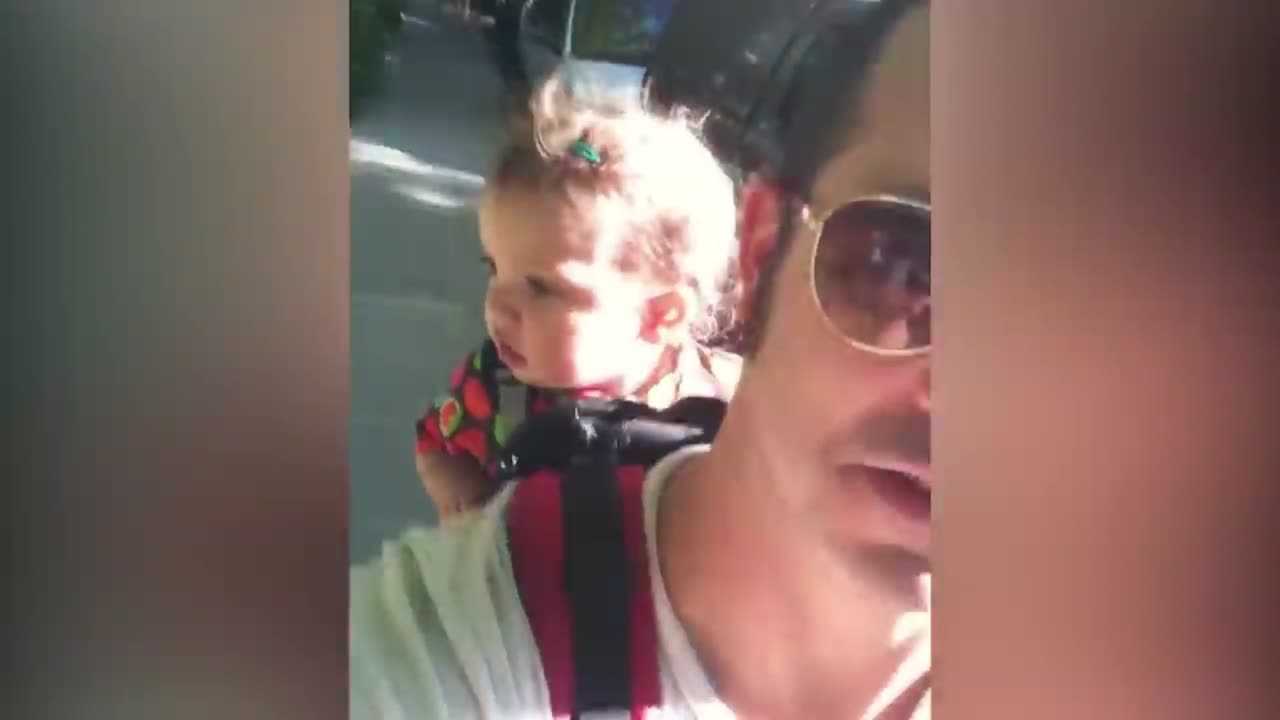 Baby has a serious conversation with his father, cute